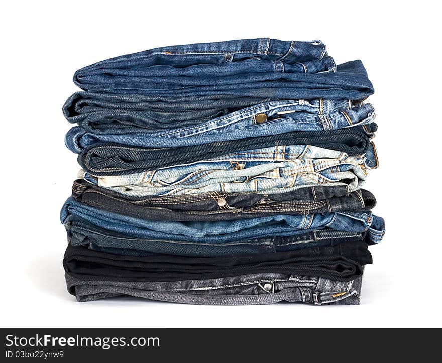 Stack of various jeans isolated on white