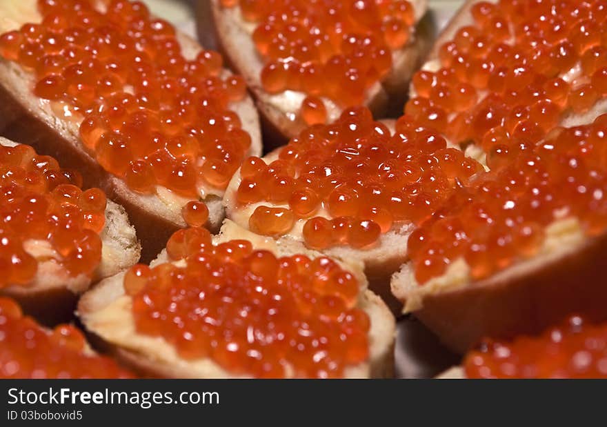 Sandwich with red caviar on the festal table