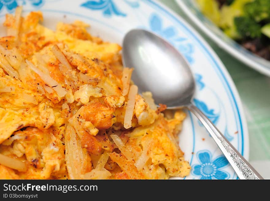 Chinese style golden brown omelet fried with sliced potato sticks.