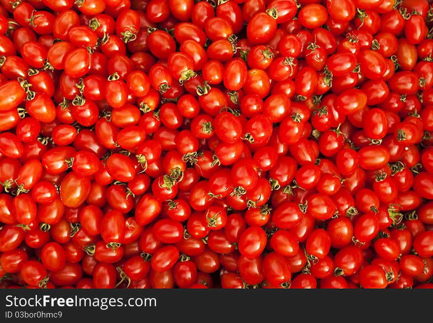 Many cherry tomatoes bathed in the sunlight on the local farmer’s market. Many cherry tomatoes bathed in the sunlight on the local farmer’s market.