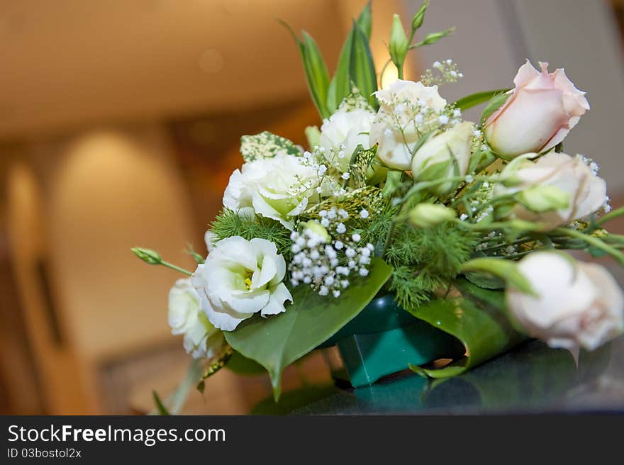 A small pot of beautiful flower petals being decorated on a table outside a ballroom, an exquisite yet abstract decoration!. A small pot of beautiful flower petals being decorated on a table outside a ballroom, an exquisite yet abstract decoration!