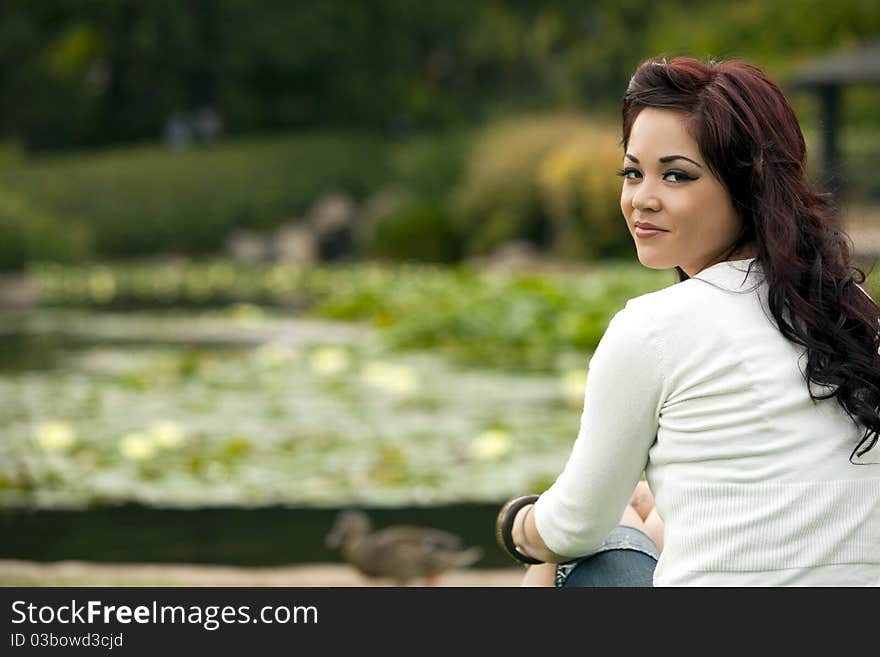 Attractive young woman sitting at the park