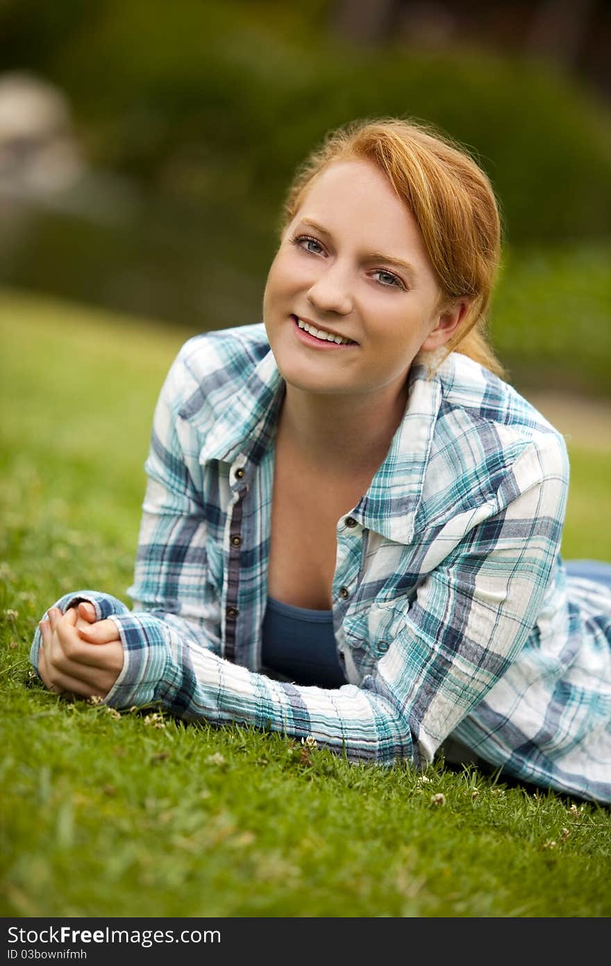 Pretty young woman sitting outside