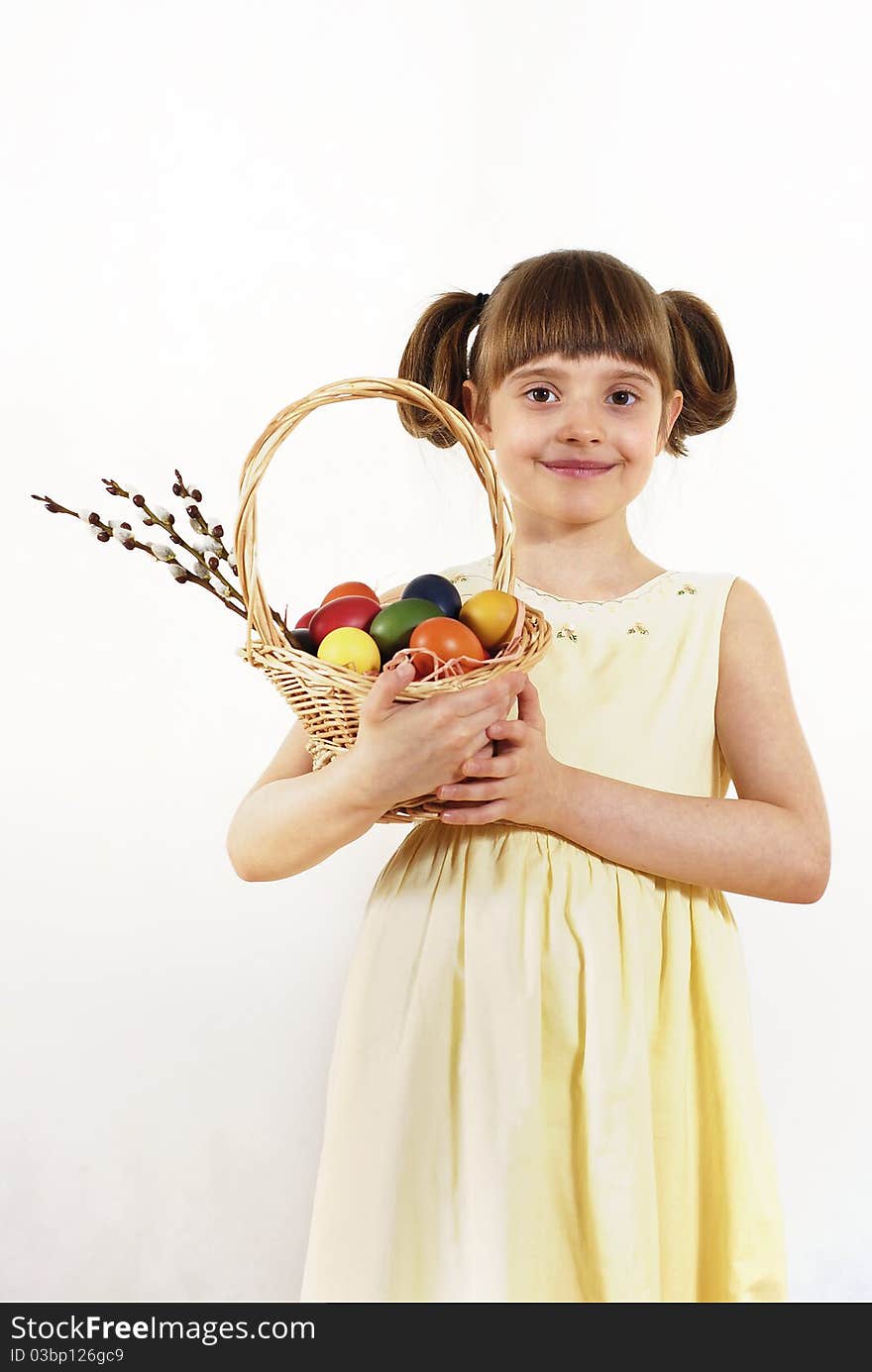 Girl keeping the basket with Easter painted eggs. Girl keeping the basket with Easter painted eggs