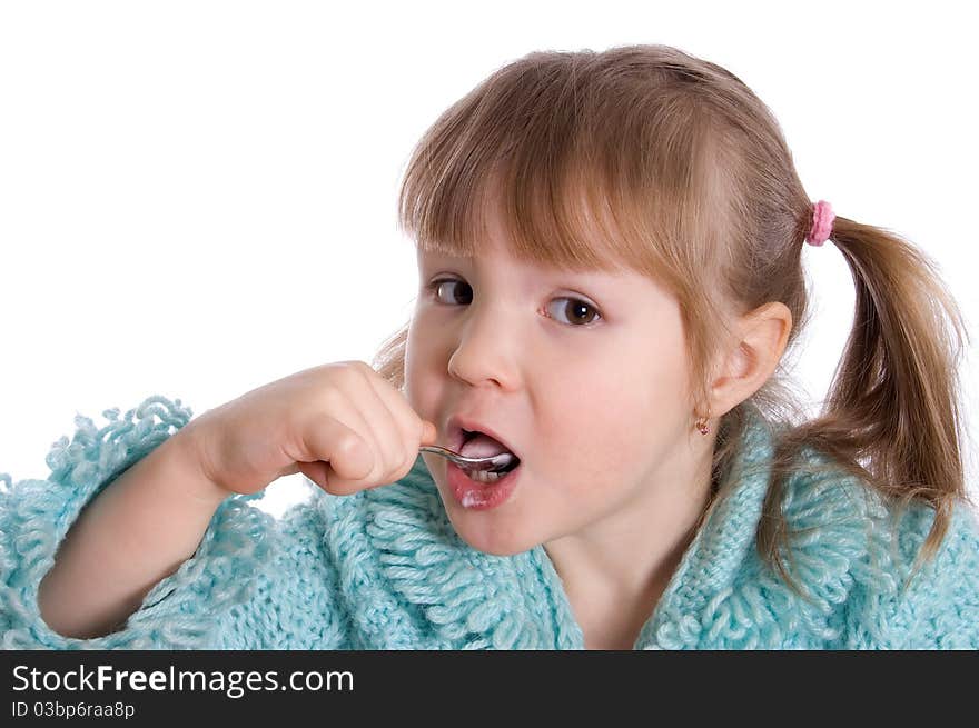 The little girl eats yoghurt on white