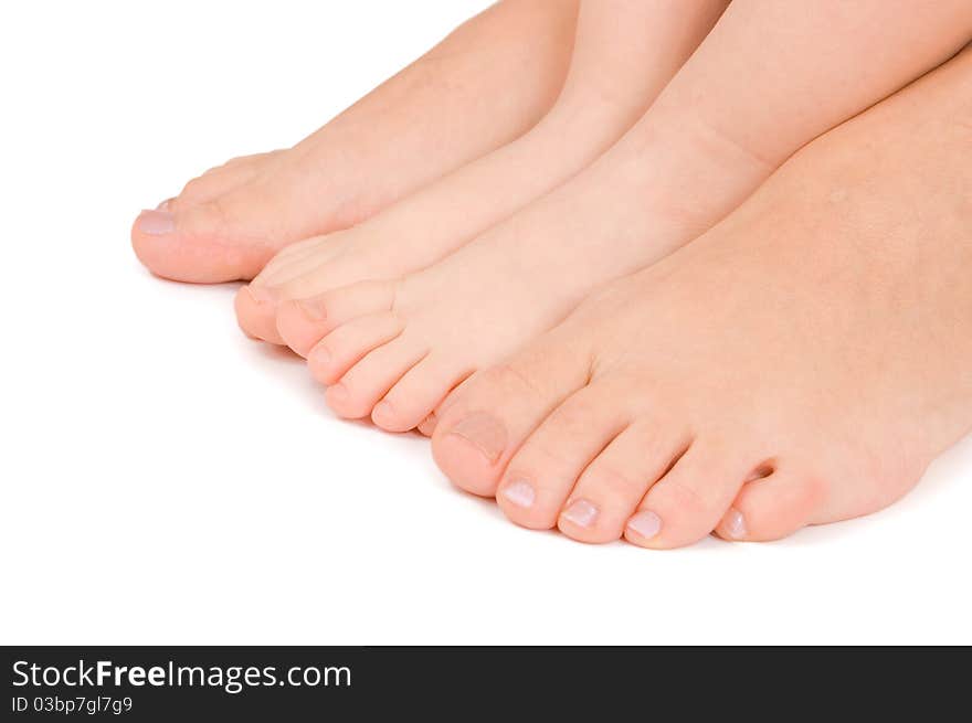 Mother and daughter feet together on white