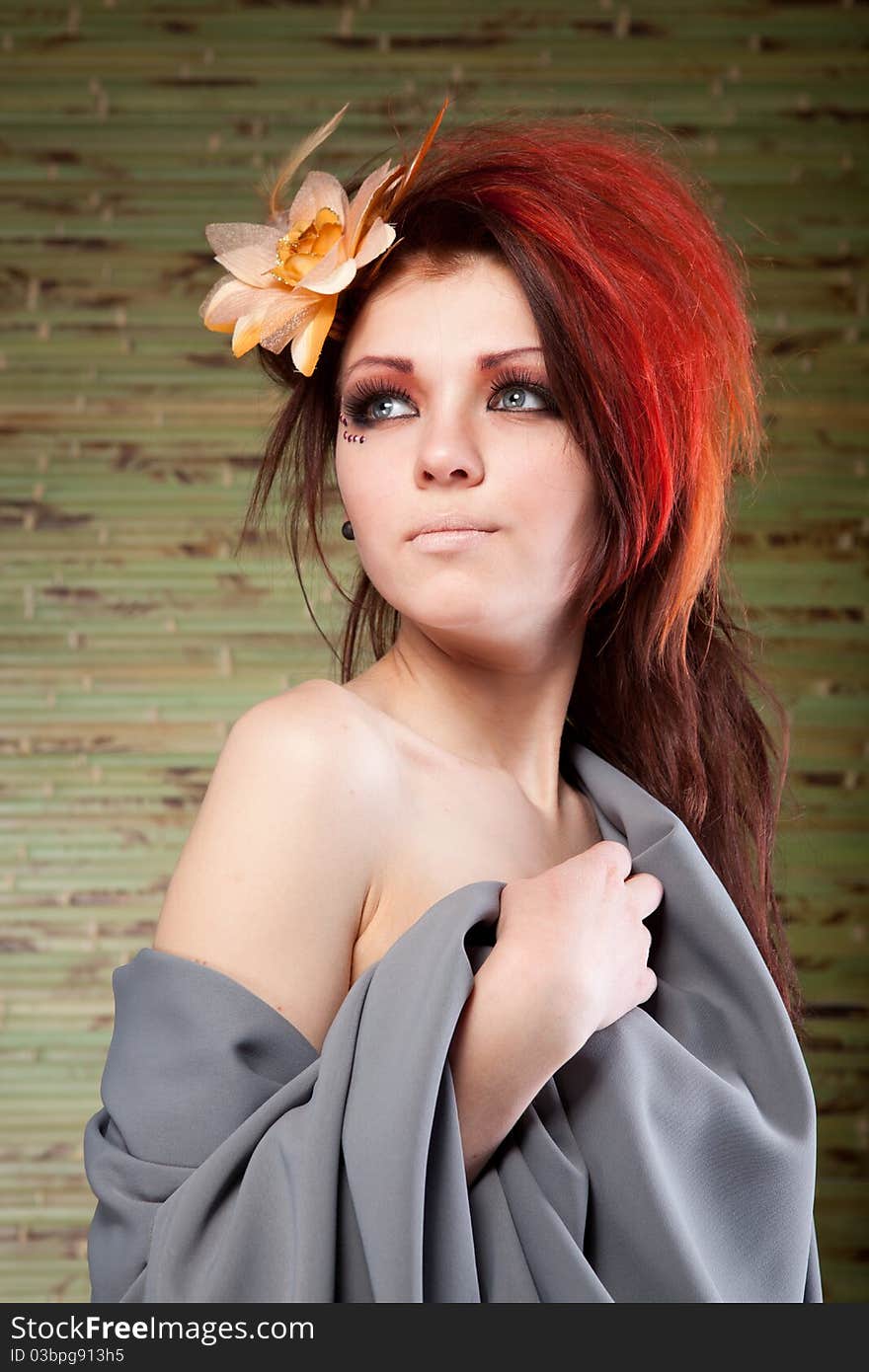 Portrait of beautiful woman with flower in hair