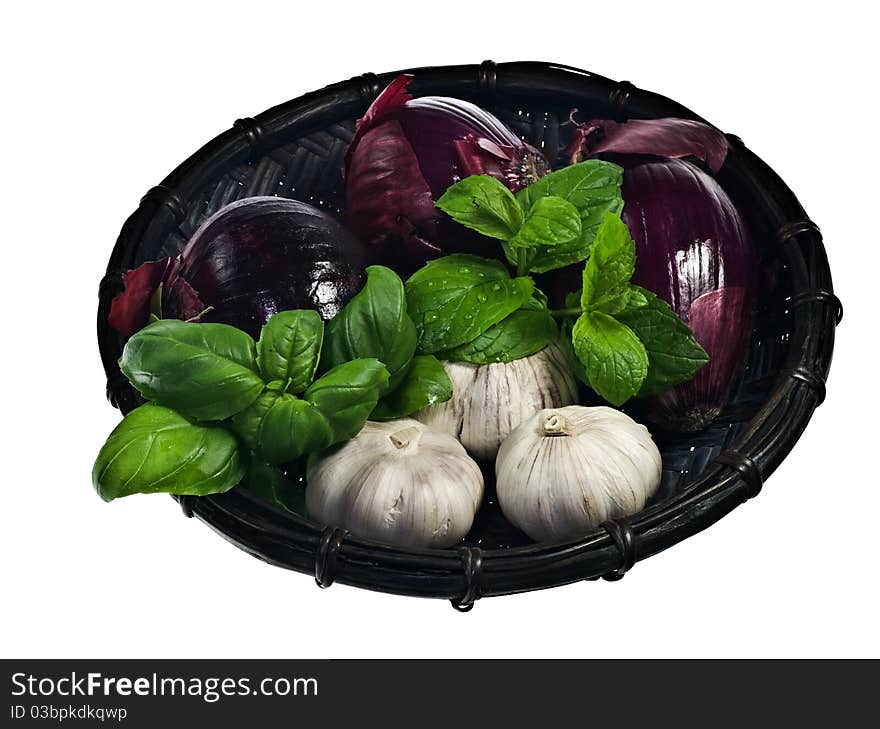 Red onions and garlic in a basket isolated on white