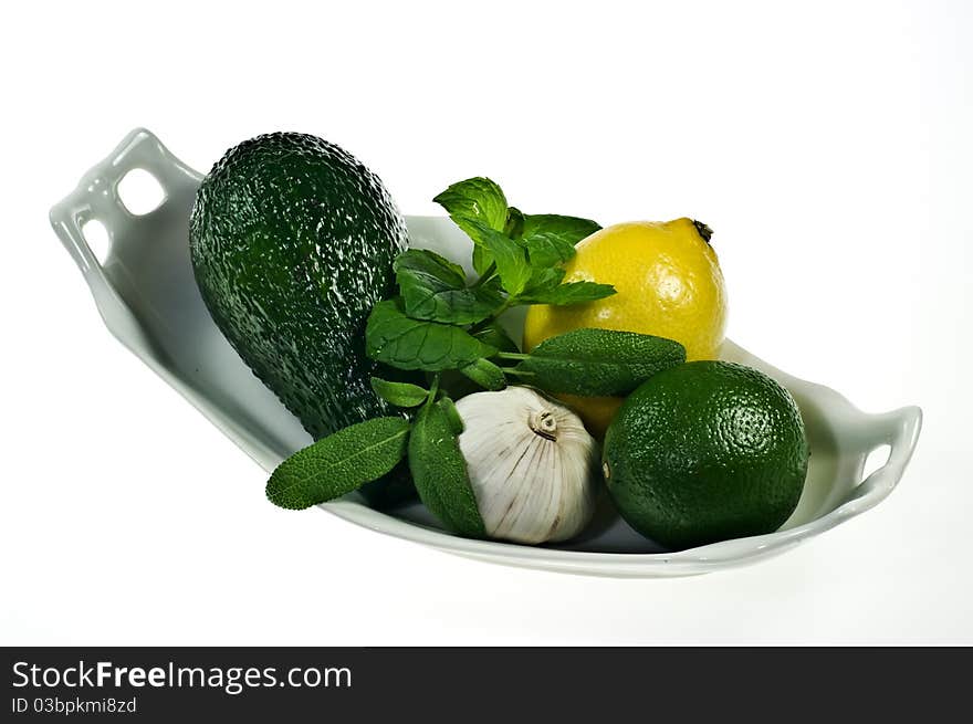 Avocado and lemons on porcelain dish