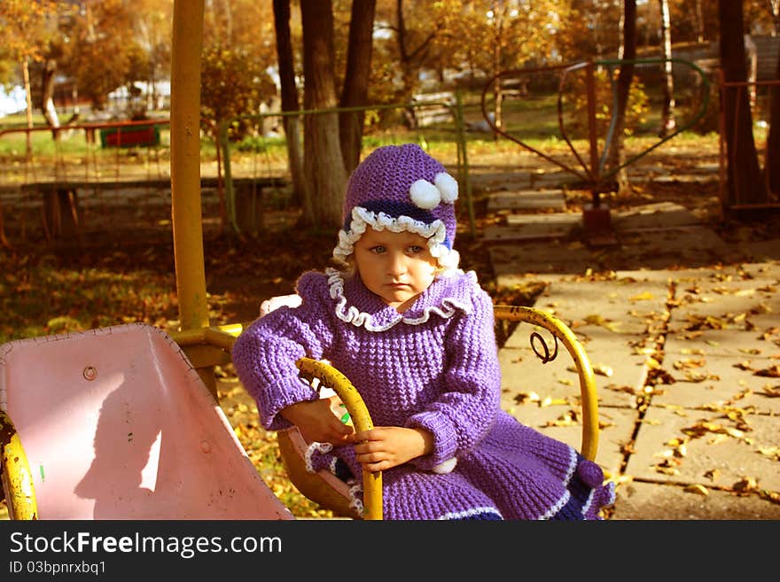 A little sad girl is in autumnal park. A little sad girl is in autumnal park