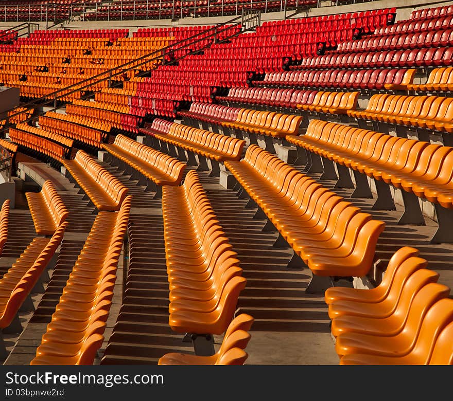 Stedium seat rows saperated by color and metal fence.