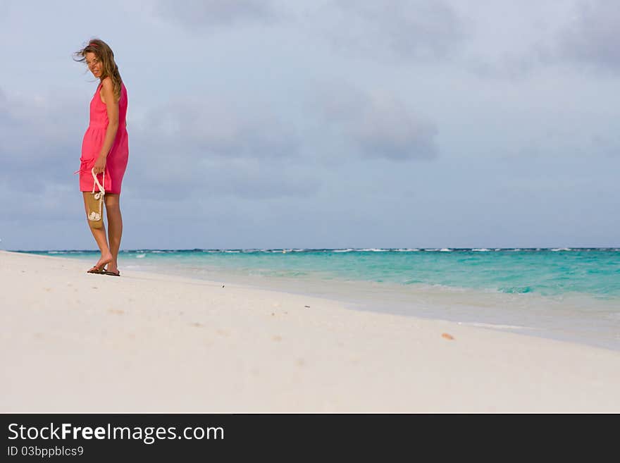 Girl goes for a walk on the coast of tropical island. Girl goes for a walk on the coast of tropical island