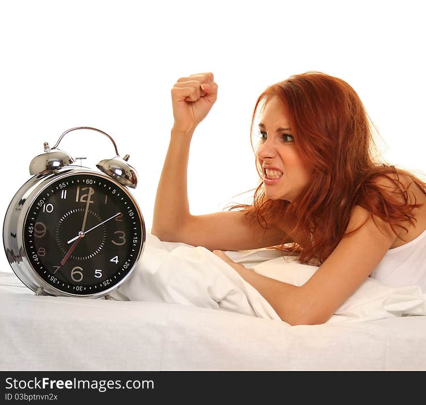 Young woman lying in bed with alarm clock. Young woman lying in bed with alarm clock