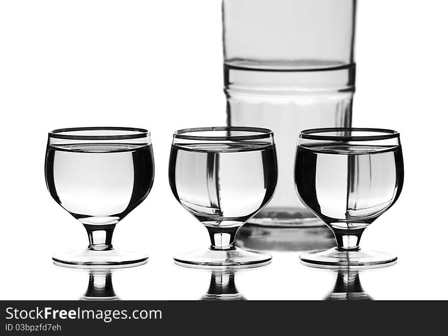 Wine glasses with a bottle. White background. Studio shot. Wine glasses with a bottle. White background. Studio shot.