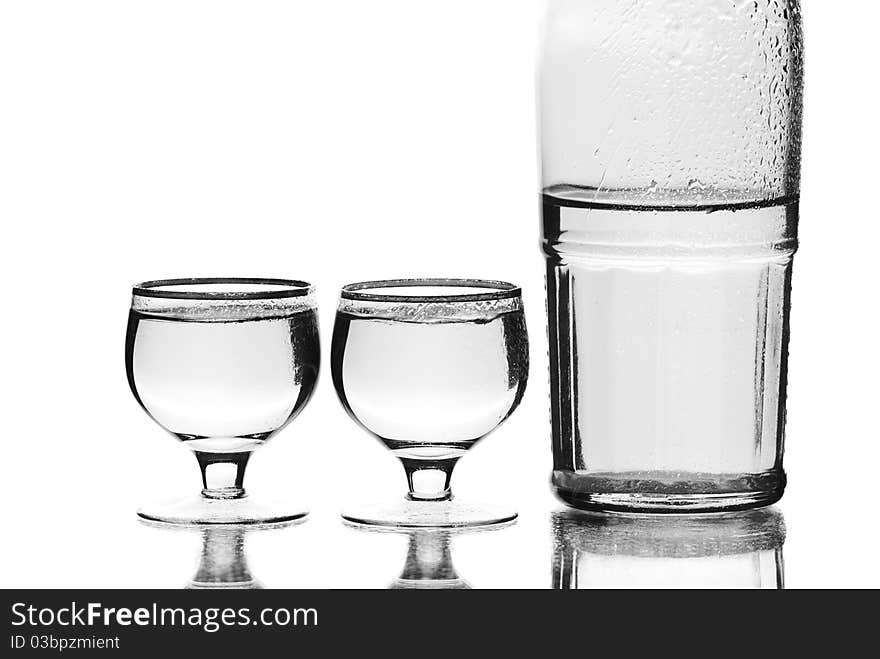 Wine glasses with a bottle. White background. Studio shot. Wine glasses with a bottle. White background. Studio shot.