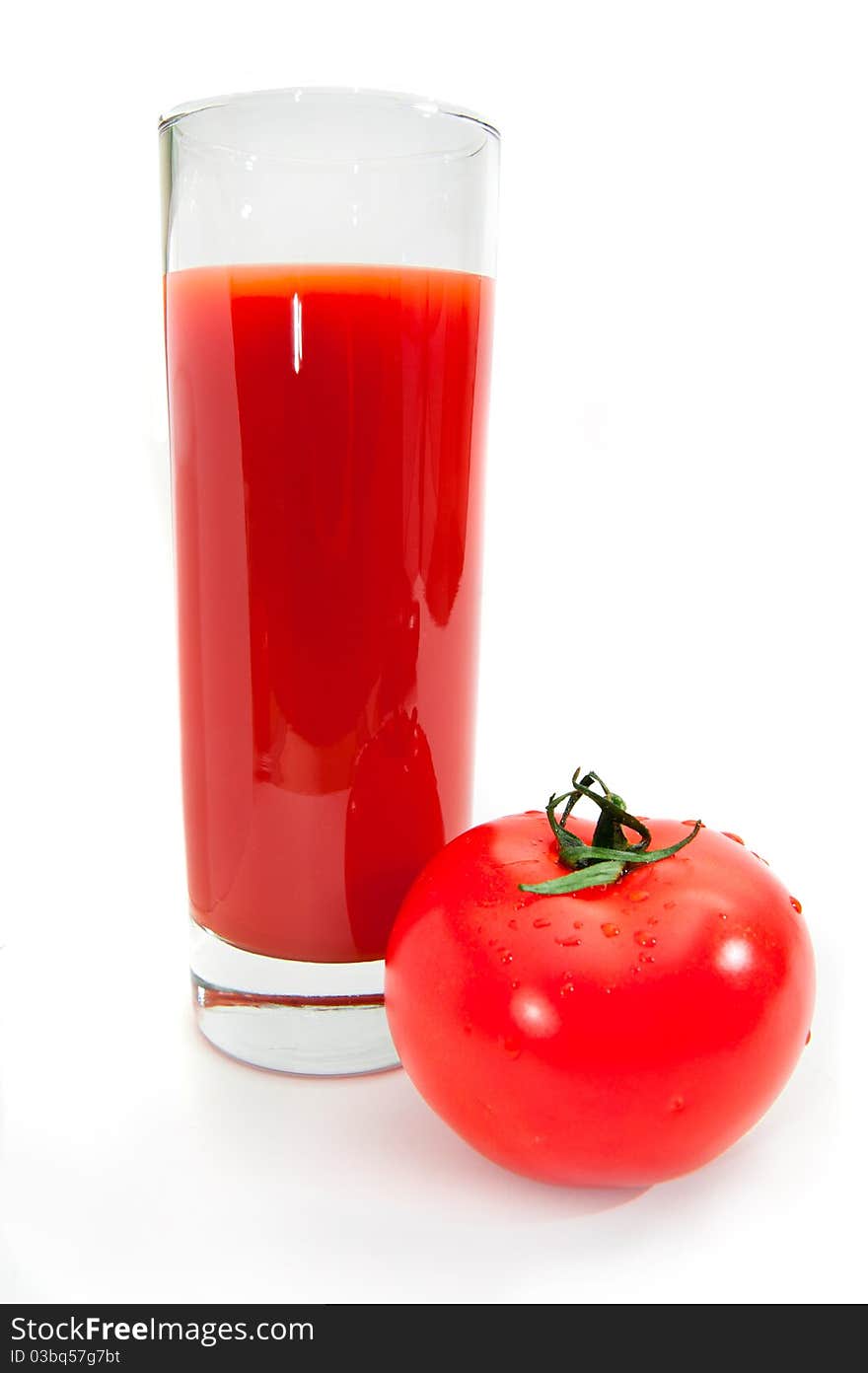 Glass of tomato juice isolated on white