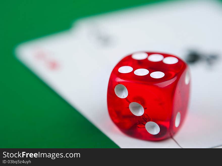 Close-up of red dices on a green background