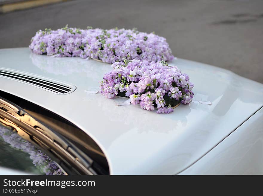 Flowers on a white wedding car. Flowers on a white wedding car