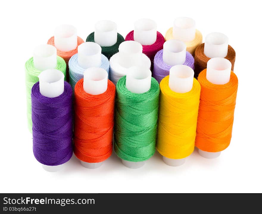 Spools multi-colored threads standing group isolated on a white background