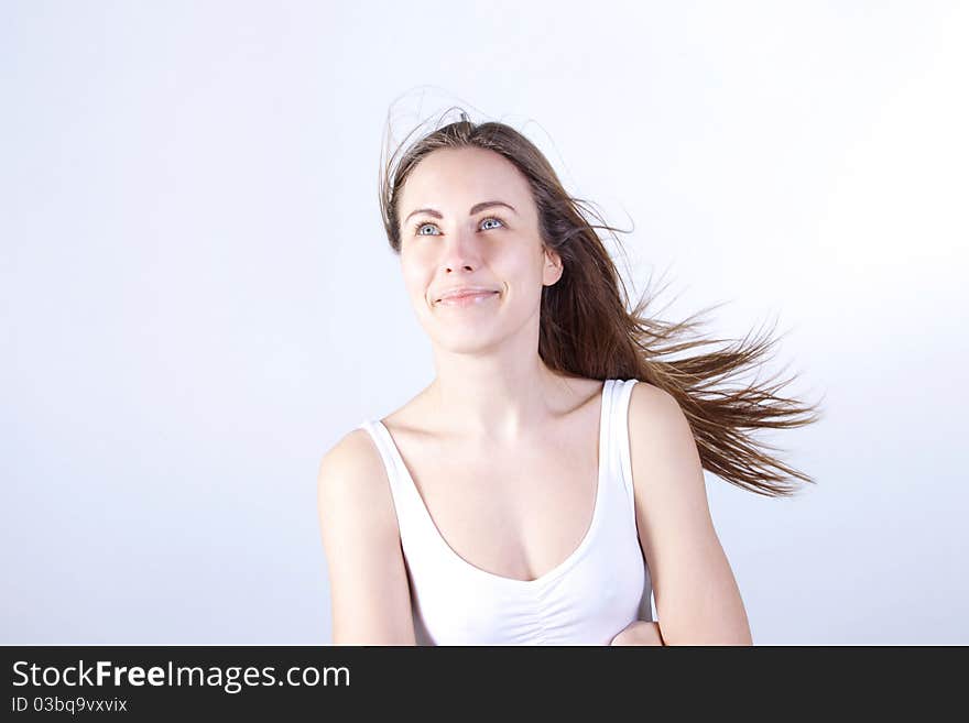 Young beautiful woman with flyaway hair, Looks upwards. Young beautiful woman with flyaway hair, Looks upwards