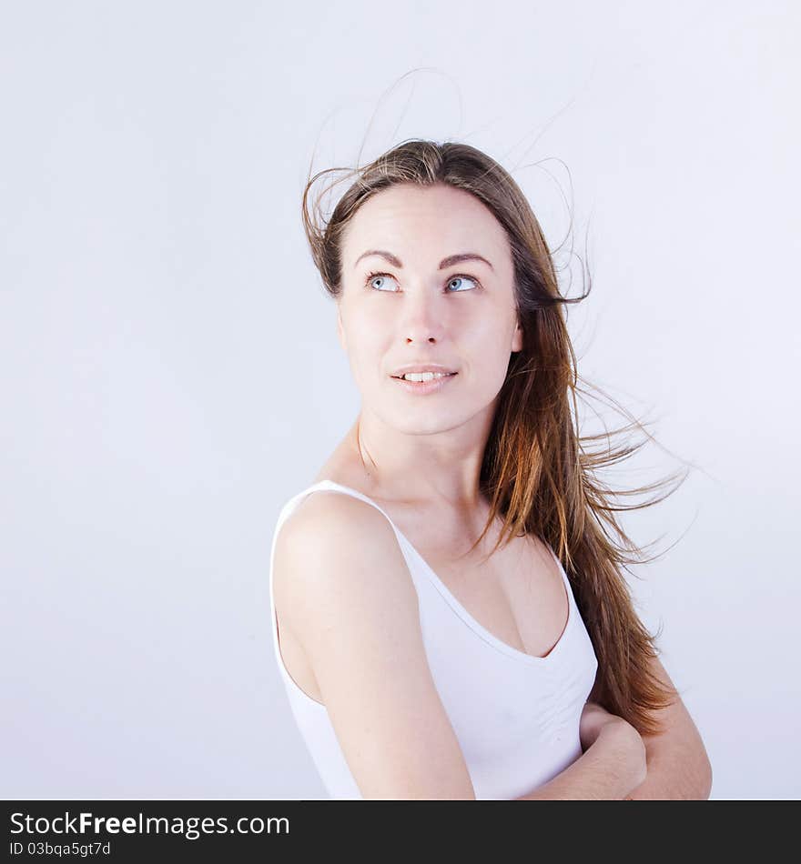 Young beautiful  woman  with flyaway hair, Looks upwards. Young beautiful  woman  with flyaway hair, Looks upwards