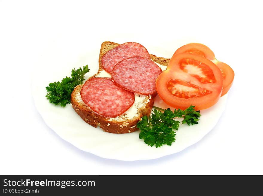 Breakfast with bread, tomatoes, parsley, salami isolated