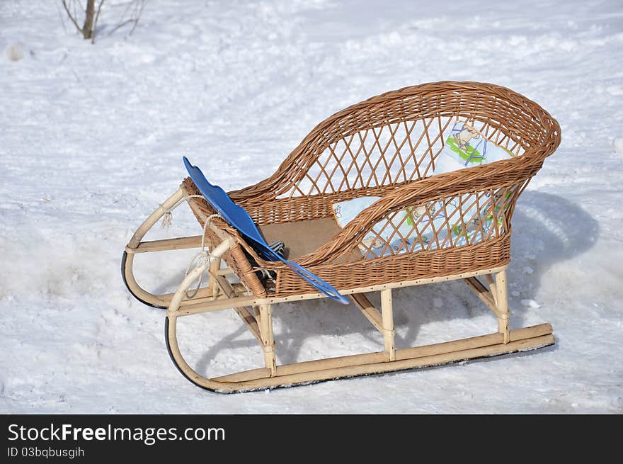 Children s wicker sled  in the snow