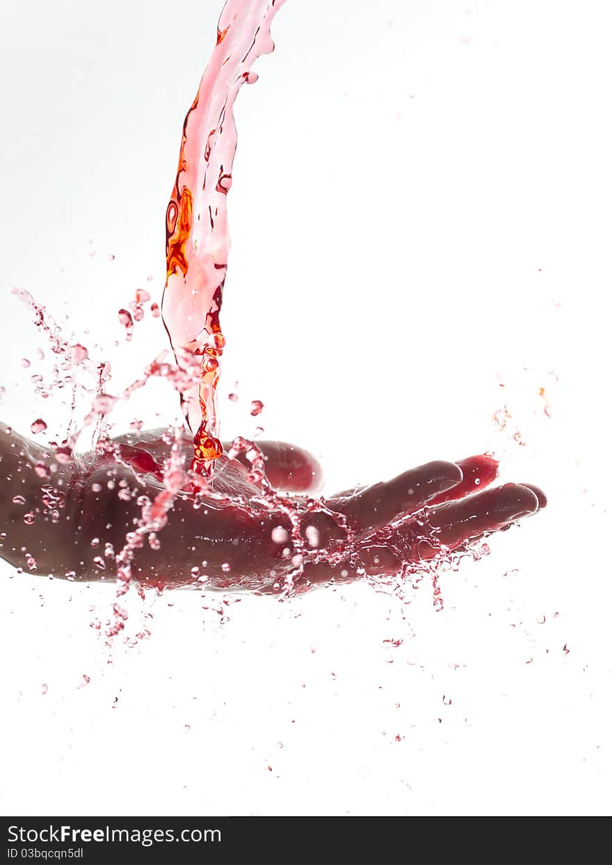 Splashing red water looking like juice or blood on hand. Splashing red water looking like juice or blood on hand