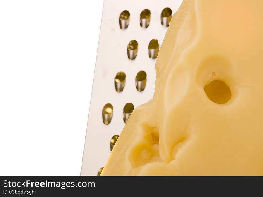 Swiss cheese slice with grater on a white background.