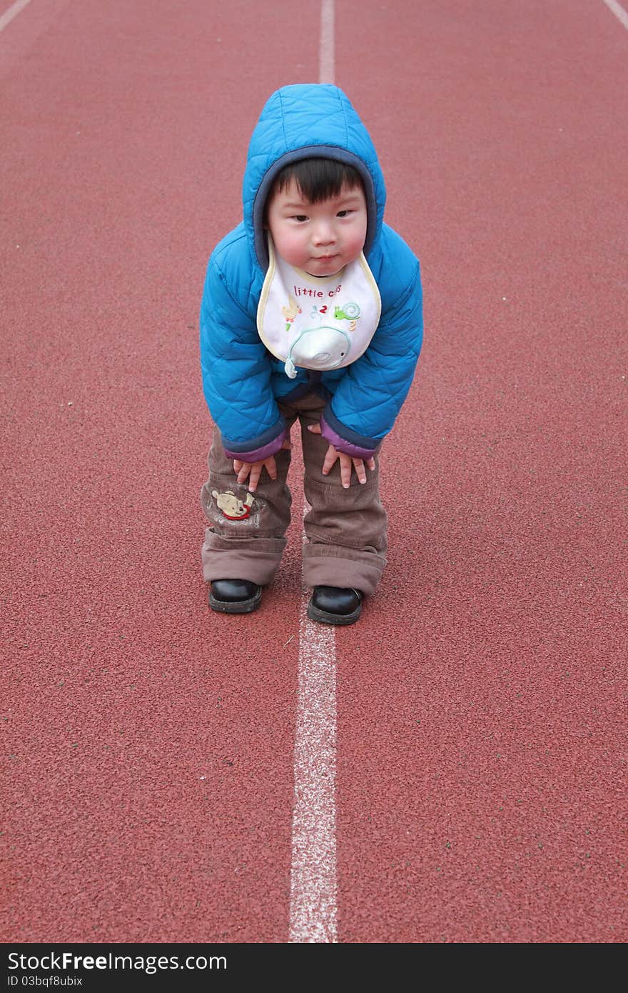 Lovely chinese boy in the sports stadium