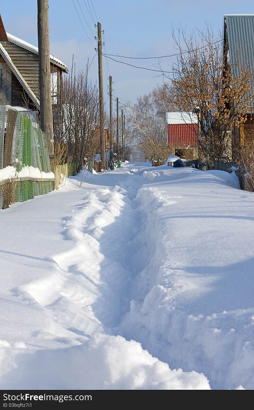 Path to  house through  drifts. Winter landscape.