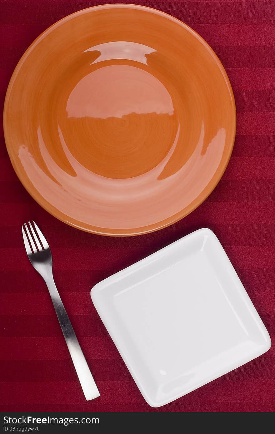 Ceramic plates for table on a red background. Ceramic plates for table on a red background.