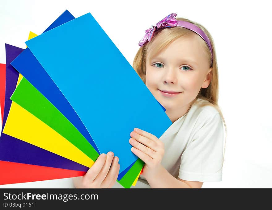 Cute little girl with the colored paper