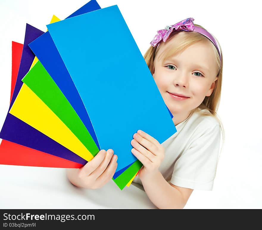 Cute little girl with the colored paper