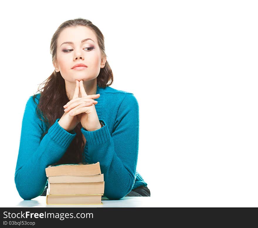 Young girl siting at the table with books and thinking. Young girl siting at the table with books and thinking