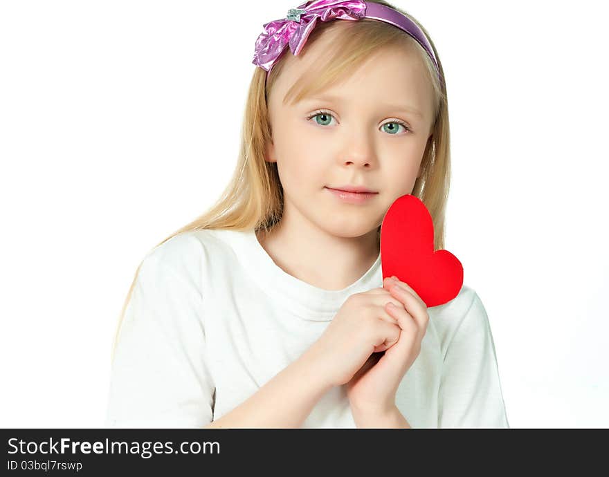 Cute little girl with red heart made of paper