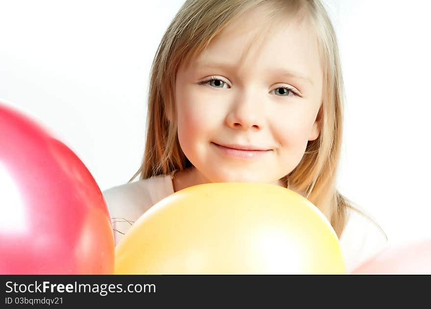 Cute little girl with balloons on white