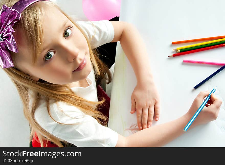 Cute little girl with colored pencils on white. Cute little girl with colored pencils on white