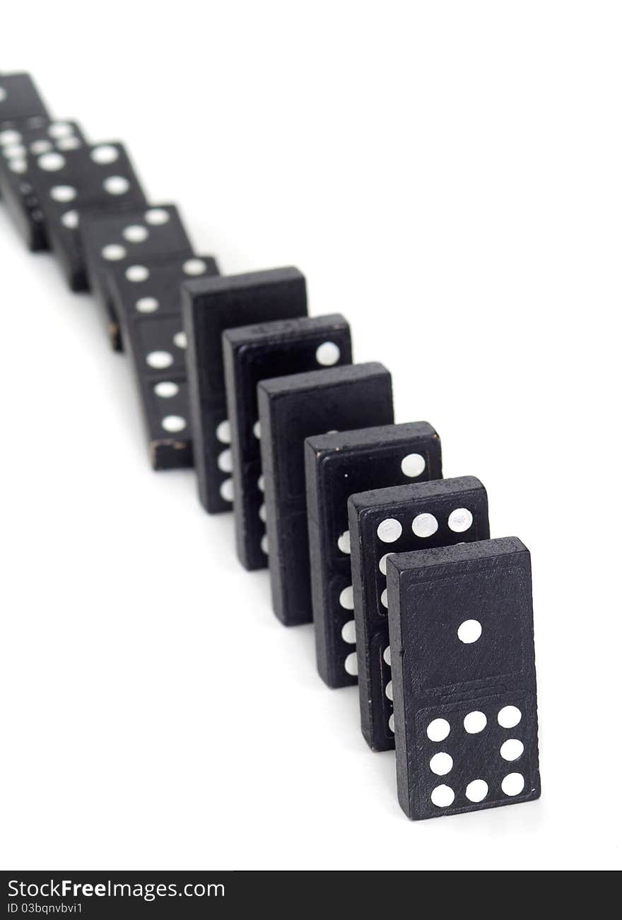 Line of dominos that are partially toppled. Line of dominos that are partially toppled