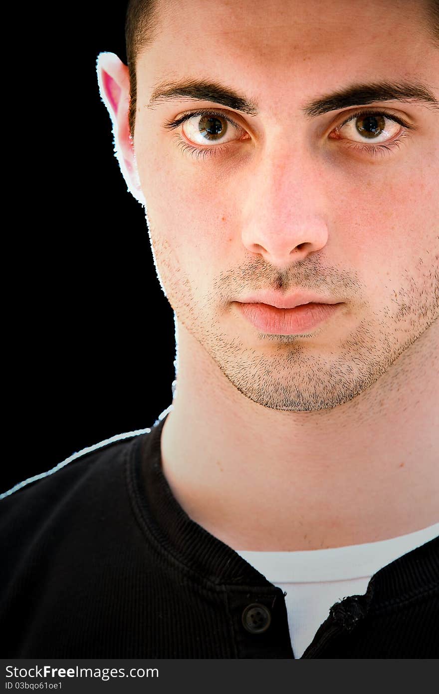 Portrait of a handsome young man, isolated on black