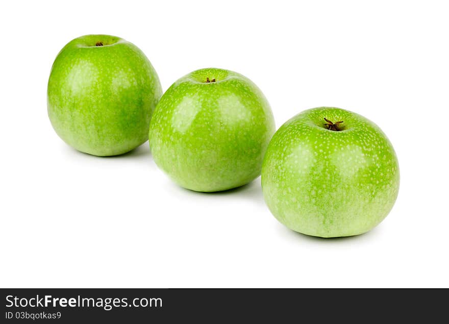 Three ripe and juicy green apples located in a line isolated on a white background. Three ripe and juicy green apples located in a line isolated on a white background