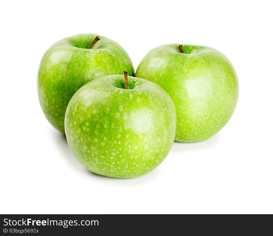 Three ripe and juicy green apples nearby with each other isolated on a white background. Three ripe and juicy green apples nearby with each other isolated on a white background