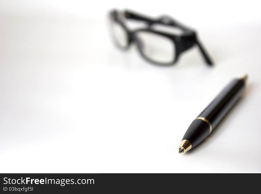 Eyeglasses and pen on isolated white background. Eyeglasses and pen on isolated white background