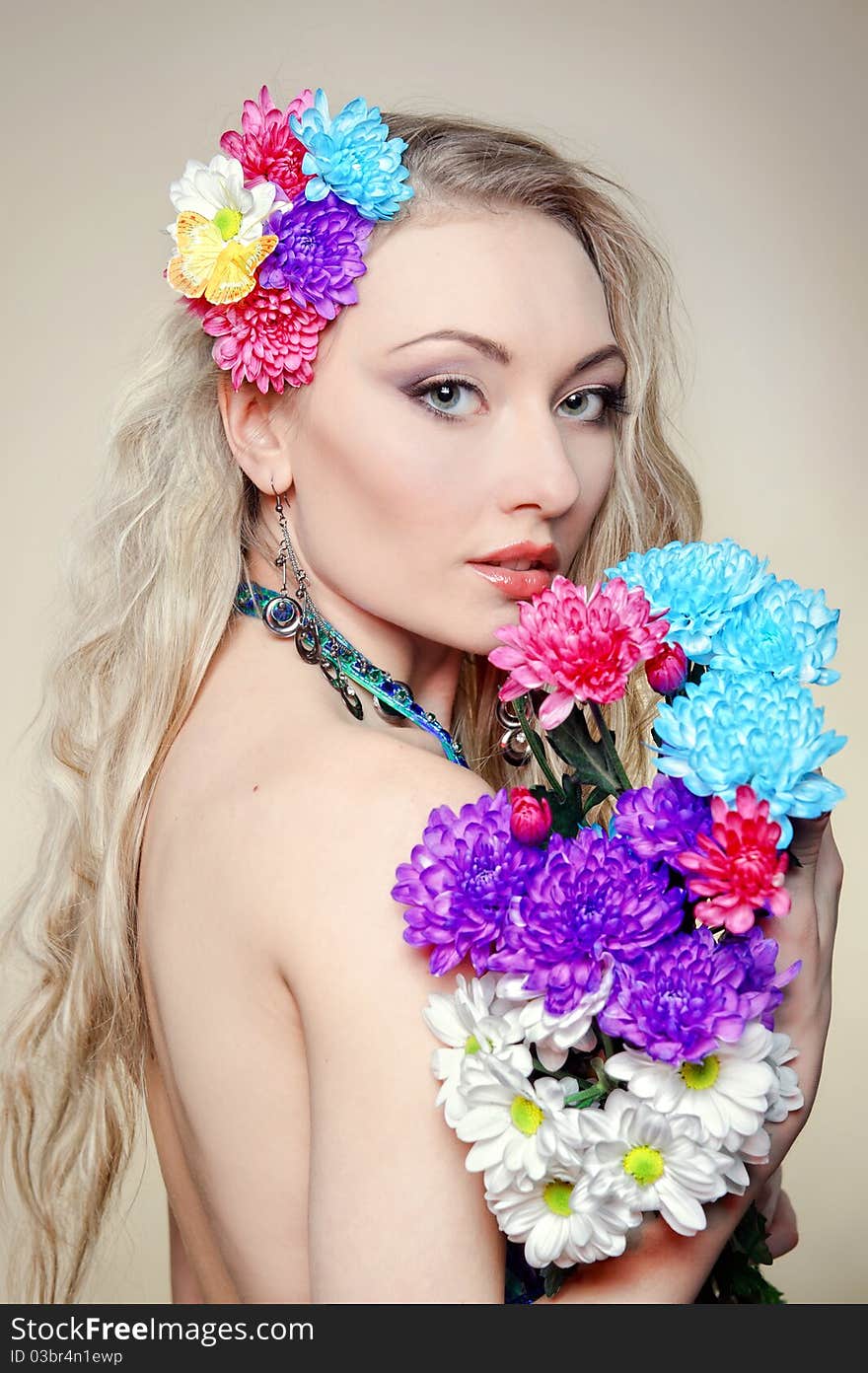 The beautiful young woman with flowers in hair. The beautiful young woman with flowers in hair