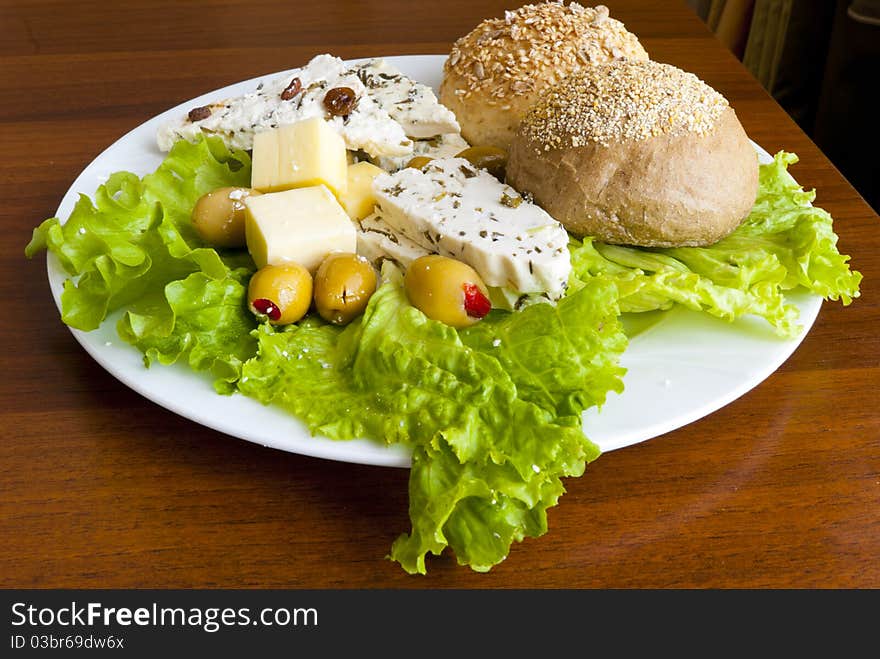 Light mediterranean lunch with cheese, bread and olives