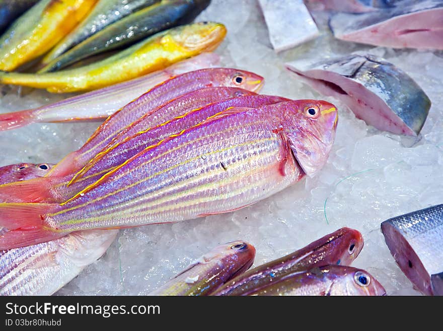 Whole fresh fishes are offered in the fish market in asia