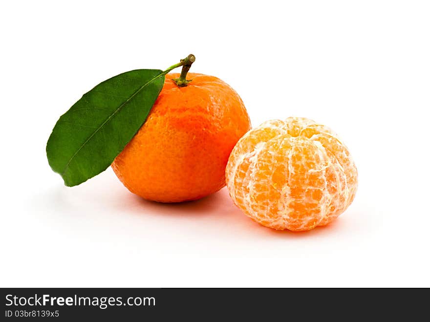 Two tangerines (one skinned) against a white background