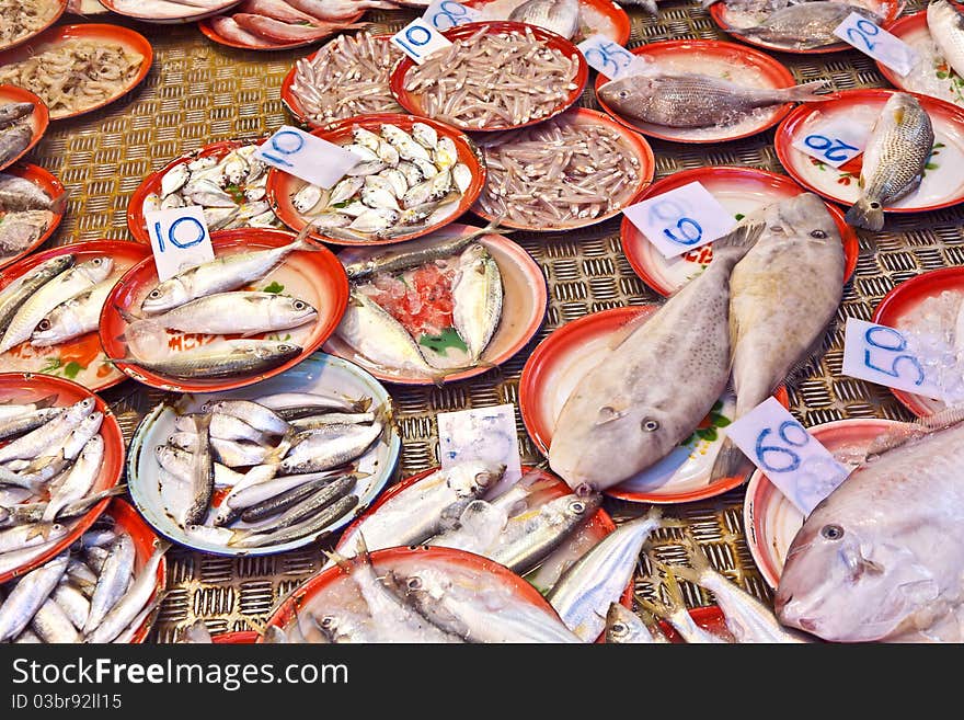 Whole fresh fishes are offered in the fish market in asia