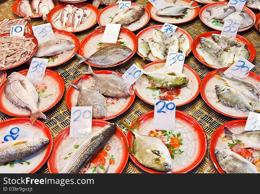 Whole fresh fishes are offered in the fish market in asia