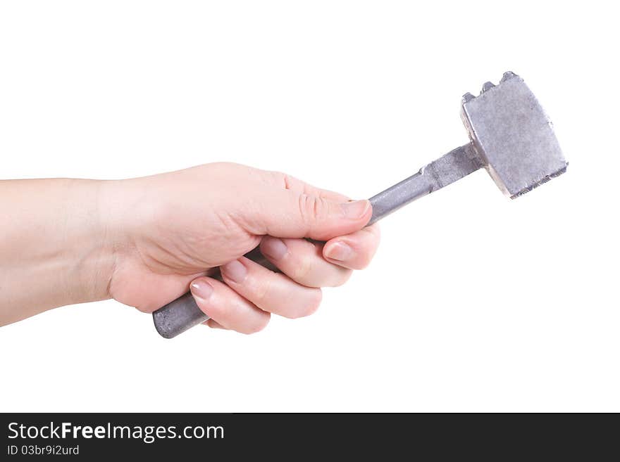 The female hand holds a metal hammer. The female hand holds a metal hammer